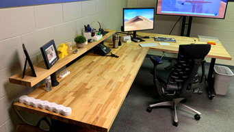 A raw barkline edge on a solid wood desktop adds a rustic touch to your work area