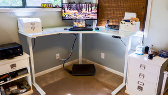 UPLIFT V2 L-Shaped Standing Desk with GREENGUARD-certified White Laminate Desktop