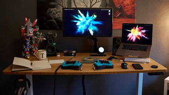 1-inch thick carbonized bamboo desktop with a raised laptop by UPLIFT Desk